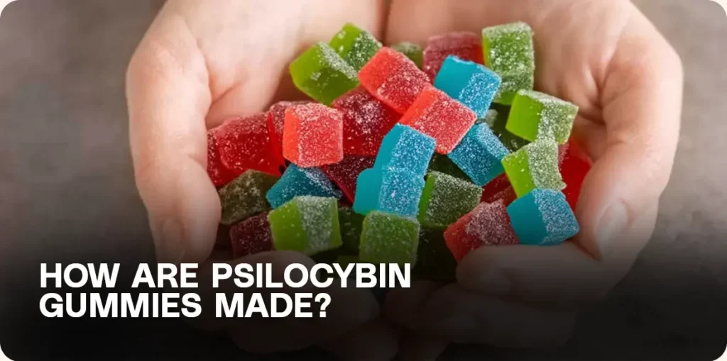 Two hands full of red, blue, and green gummies.
