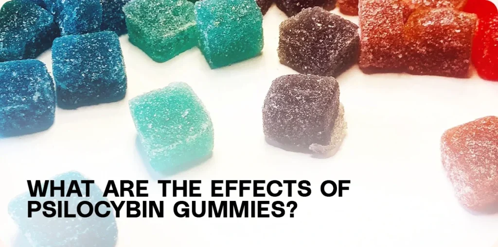 Blue, green, and red square gummies on a white surface